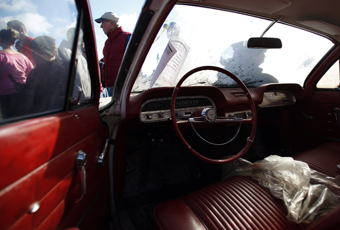 Potential buyers and car enthusiast check out a 1963 Corvair that is part of the vintage automobiles from the Lambrecht Collection before being put up for auction in Pierce, Nebraska, September 28, 2013. Over 500 classic cars and trucks from an inventory collected by Ray and Mildred Lambrecht will be sold over the weekend. REUTERS/Jim Urquhart  (UNITED STATES)