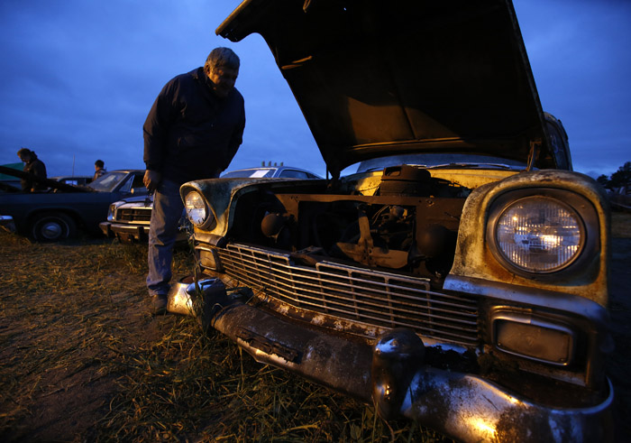 Marty Zabel checks out the vintage a 1956 Chevrolet from the Lambrecht Collection before being put up for auction in Pierce, Nebraska, September 28, 2013. Over 500 classic cars and trucks from an inventory collected by Ray and Mildred Lambrecht will be sold over the weekend. REUTERS/Jim Urquhart  (UNITED STATES)