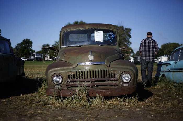 Potential buyers and car enthusiast walk past a International truck that was part of the vintage automobiles from the Lambrecht Collection put up for auction in Pierce, Nebraska, September 28, 2013. Over 500 classic cars and trucks from an inventory collected by Ray and Mildred Lambrecht will be sold over the weekend. REUTERS/Jim Urquhart  (UNITED STATES)