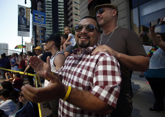 Angel Elias, left, and his partner Clyde Sayler watch the gay pride parade in Salt Lake City, Utah, June 2, 2013. Both active Mormons and members of the Boy Scouts marched with members of LGBT community and their supporters as part of the Utah Pride Festival. REUTERS/Jim Urquhart (UNITED STATES)
