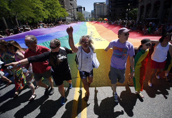 Gay rights supporters march with a rainbow flag the gay pride parade in Salt Lake City, Utah, June 2, 2013. Both active Mormons and members of the Boy Scouts marched with members of LGBT community and their supporters as part of the Utah Pride Festival. REUTERS/Jim Urquhart (UNITED STATES)